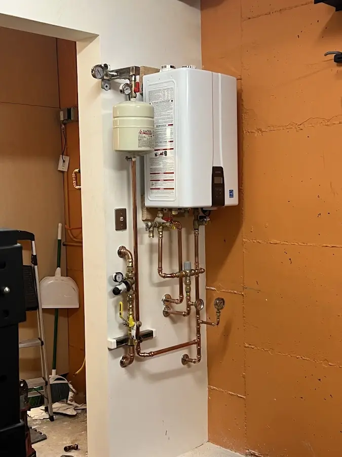 Plumbing technician inspecting water heater connections in High Bridge